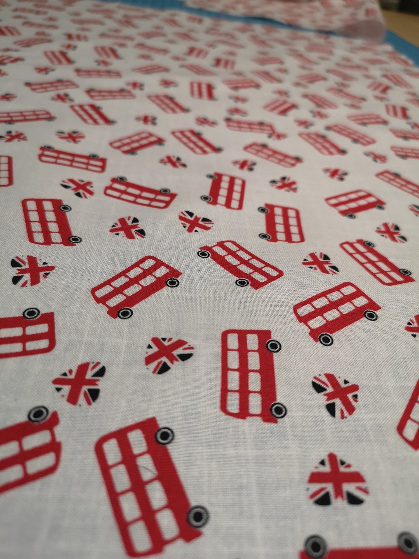 100% Cotton fabric: red London bus, flowers, roses, Japanese dolls, grey turquoise stars, Debbie Shore sewing machine, cherry blossom