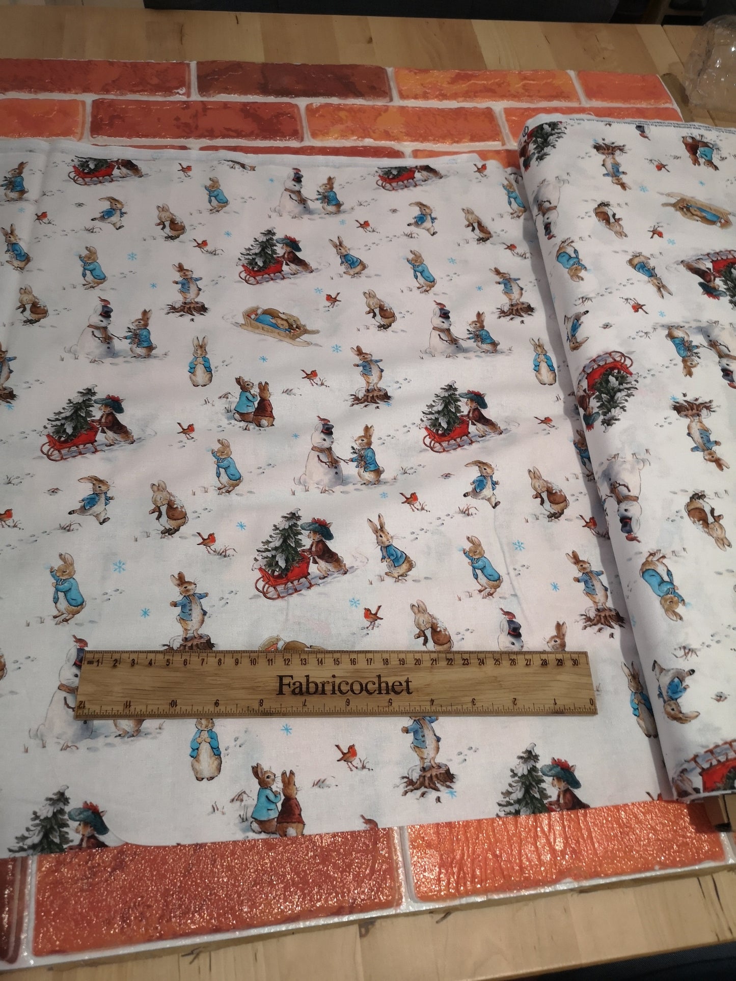 Licensed Peter Rabbit Christmas cotton: rabbits, Christmas pudding, snowman, sledge, stockings, Robins, presents, wreath, snow, tree