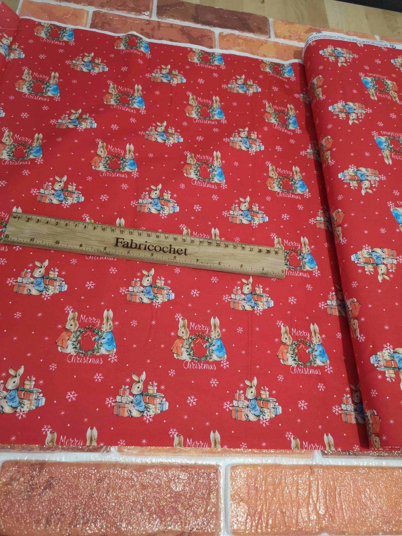 Licensed Peter Rabbit Christmas cotton: rabbits, Christmas pudding, snowman, sledge, stockings, Robins, presents, wreath, snow, tree